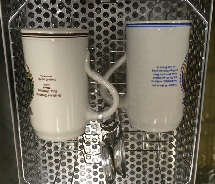2 clean mugs in a metal basket
